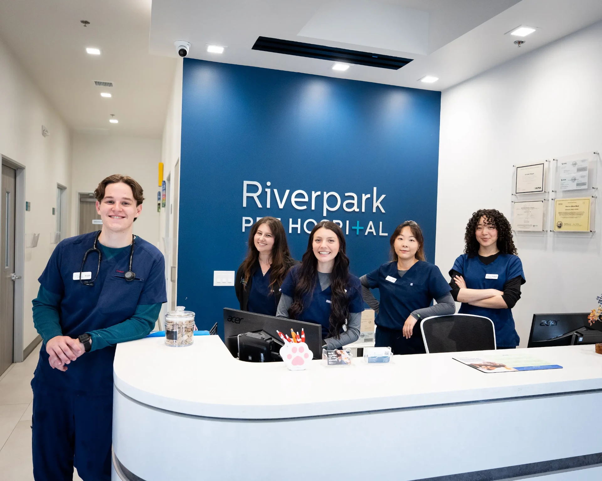 Veterinarian welcoming a new client and their dog at Riverpark Pet Hospital