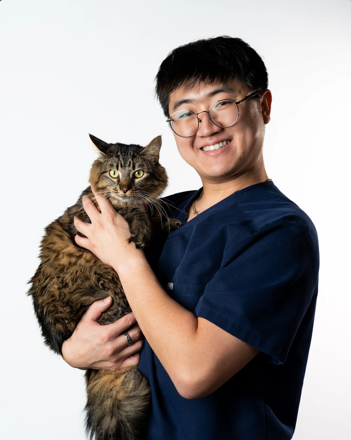 Riverpark Pet Hospital team member with a long-haired tabby cat