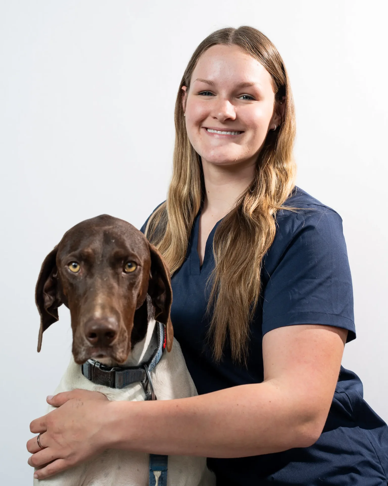 Riverpark Pet Hospital team member with a German Shorthaired Pointer
